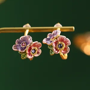 Close-up detail of vintage Monet garden style floral enamel earrings with vibrant colors
