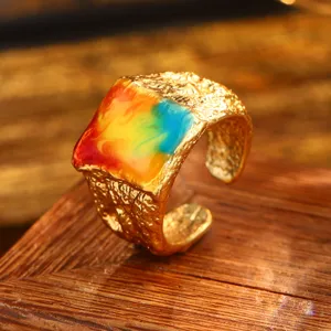 Close-up of vintage Baroque gold ring with colorful oil painting enamel inlay