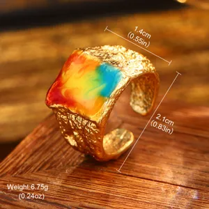Detailed view of vintage gold hammered ring with colorful oil painting enamel inlay