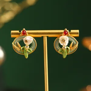 Macro view of vintage Monet garden floral earrings with pearls and red gemstones