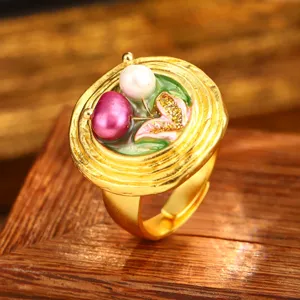 Close-up of vintage baroque gold ring with natural pearls and floral enamel details
