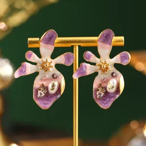 Detail view of Monet garden style enamel flower earrings with pearls and butterflies.