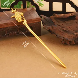 Detail view of golden vintage hairpin with dragon and cloud patterns showing size.