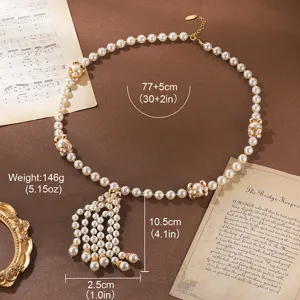 Detailed macro view of vintage pearl tassel necklace with size and weight specifications