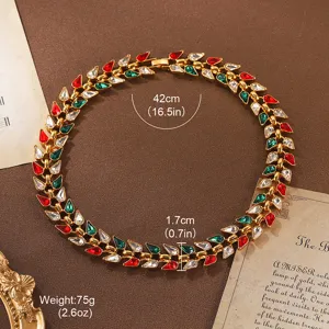 Detail view of vintage gold-tone necklace with red and green crystals and measurements