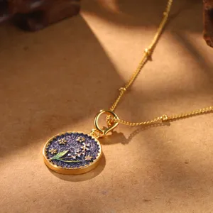 Detailed view of vintage Lily of the Valley birth flower pendant in gold and blue