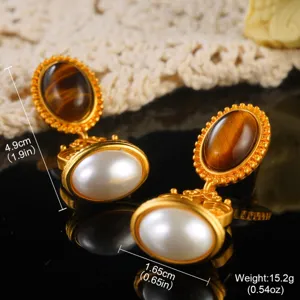 Detailed macro view of vintage palace style gold pearl earrings showing dimensions and weight