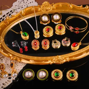 Vintage palace style jewelry set with enamel earrings and pearl necklaces on mirror
