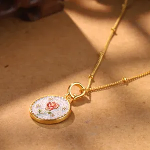 Detail view of retro rose pendant necklace with elegant gold finish and versatile clasp