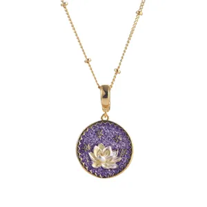 Macro detail of a vintage gold lotus flower pendant necklace with purple enamel texture