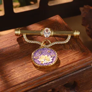 Detailed view of vintage Chinese style lotus flower brooch with purple enamel and gold finish