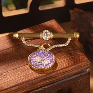 Close-up of vintage palace style gold brooch with purple enamel flower and zircon