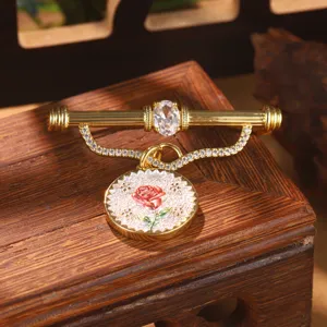 Vintage gold rose brooch with crystal and floral charm detail