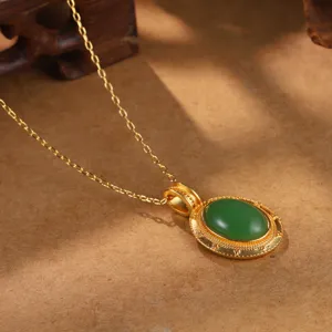 Detailansicht einer goldenen Vintage-Halskette mit ovalem grünem Cabochon-Stein
