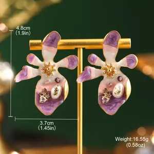 Macro view of vintage Monet style flower earrings with size and weight information