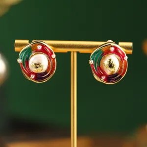 Close-up detail of vintage oil painting style earrings featuring natural pearl and gold leaf