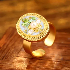 Exquisite macro detail of vintage Baroque style floral ring with central pearl on wood