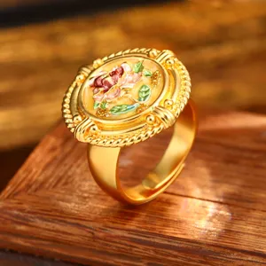 Exquisite detail of a vintage baroque gold ring featuring a colorful oil painting flower design