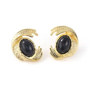 Vintage gold textured stud earrings featuring an elegant black oval centerpiece design