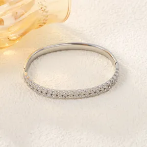 Detailed macro view of a silver stainless steel bangle featuring a delicate wheat ear design.