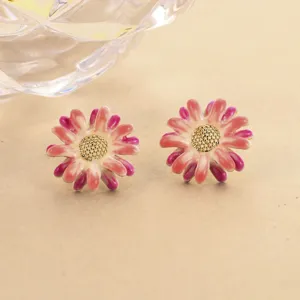 Macro view of enamel flower stud earrings featuring pink gradient petals and gold center