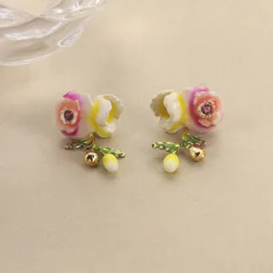 Detailed view of handmade enamel flower earrings with crystal center and leaf accents