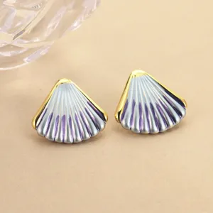 Macro detail of elegant enamel gradient shell-shaped stud earrings with gold trim