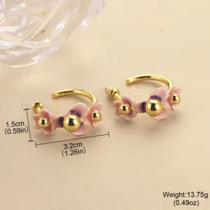Detailed view of pink enamel flower hoop earrings with gold beads and size labels