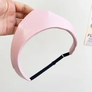 Detailed view of pink leather crown headband with adjustable elastic strap