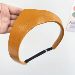 Detailed view of the yellow leather crown headband with adjustable elastic strap