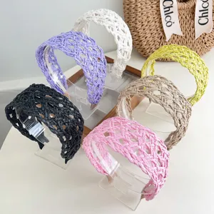 Detailed display of colorful woven straw headbands featuring hollow-out braided design