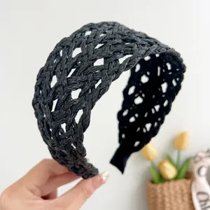 Close-up detail of a stylish black woven rattan wide headband for summer vacation