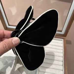Pince à cheveux papillon en velours noir avec liseré blanc élégant pour femme