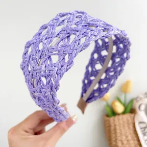 Detail view of the intricate purple hand-woven straw headband for a vacation style