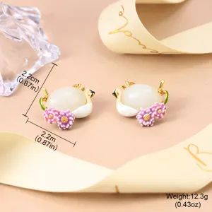 Detailed macro view of Chinese-style enamel swan flower earrings with size and weight