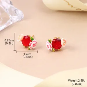 Detailed macro view of vintage enamel flower stud earrings with size and weight
