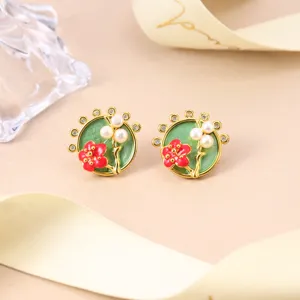 Detailed close-up of Chinese style enamel floral stud earrings featuring delicate pearls.