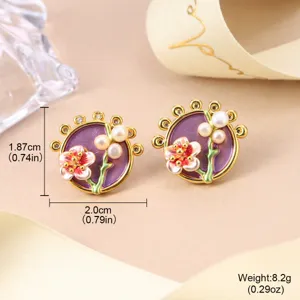 Detail view of vintage enamel flower stud earrings with white pearls and purple inlay.