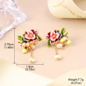 Macro view of New Chinese style enamel flower earrings with delicate pearl tassels