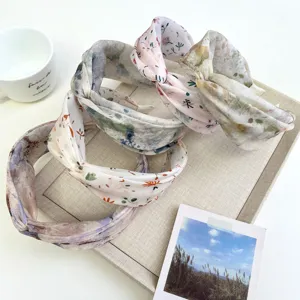 Detailed macro view of elegant floral patterned wide knotted headbands for women