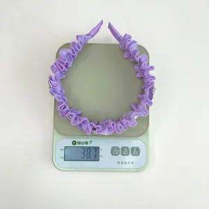 Detaillierte Gewichtsmessung von 38,7g für ein lilafarbenes, gerafftes Haarband mit Rosen