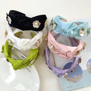 Elegant knotted satin headbands with metal flowers and pearls in multiple colors