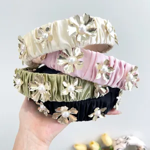 Elegant pleated headbands with gold metal flowers and pearl accents, shown in four colors.