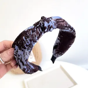 Detailed macro view of tie-dye knotted fabric wide headband for women