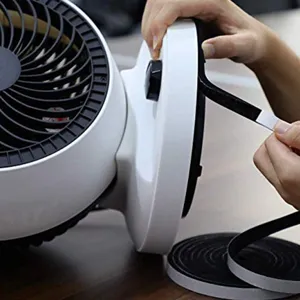 Detail shot of black self-adhesive felt tape applied to the base of a white desk fan.