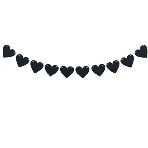 Close-up detail of gothic black felt heart garland banner for romantic decorations