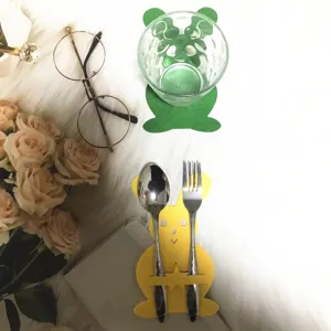 Close-up of yellow rabbit felt cutlery holder for Easter table decoration with fork and spoon