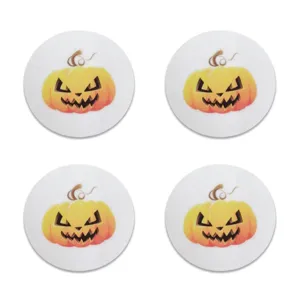 Detail showing four white felt Halloween coasters with jack-o-lantern pumpkin prints