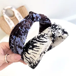 Detailed view of wide fabric headbands featuring a stylish tie-dye pattern and knot.