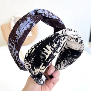 Detail of tie-dye knotted wide headbands with stylish black, white and blue patterns.